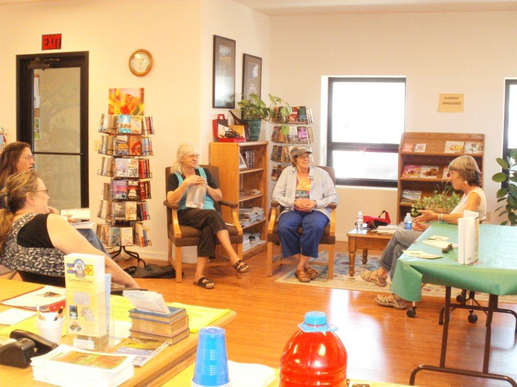 group of women, including Mary, sit in a circle in the library having discussion